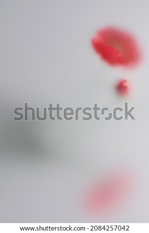 Nature background with flower behind patterned glass