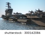 Navy aircraft carrier angled view, with a large compartment of aircraft and crew.