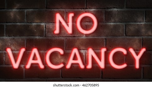 Neon sign against brick wall "no vacancy"