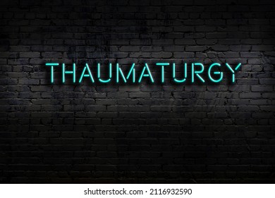 Neon Sign On Brick Wall At Night. Inscription Thaumaturgy