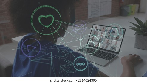 Network of digital icon floating against african american woman having a image conference on laptop. global networking and business technology concept