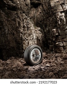 A New Car Wheel Standing On A Rocky Stage. A Car Tire Standing Upright And Sideways On Rocky Ground In Front Of A Natural Cliff. 3d Rendering, No People