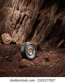 A New Car Wheel Standing On A Rocky Stage. A Car Tire Standing Upright And Sideways On Rocky Ground In Front Of A Natural Cliff. 3d Rendering, No People