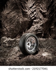 A New Car Wheel Standing On A Rocky Stage. A Car Tire Standing Upright And Sideways On Rocky Ground In Front Of A Natural Cliff. 3d Rendering, No People