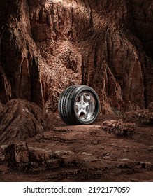 A New Car Wheel Standing On A Rocky Stage. A Car Tire Standing Upright And Sideways On Rocky Ground In Front Of A Natural Cliff. 3d Rendering, No People