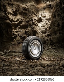 A New Car Wheel Standing On A Rocky Stage. A Car Tire Standing Upright And Sideways On Rocky Ground In Front Of A Natural Cliff. 3d Rendering, No People