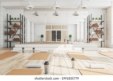 New Concrete Yoga Gym Interior With Equipment, Daylight And Wooden Flooring. Healthy Lifestyle Concept. 3D Rendering