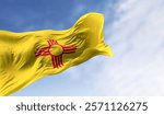 New Mexico state flag waving in the wind on a clear day. Red sun symbol of the Zia people on yellow field. 3d illustration render. Selective focus