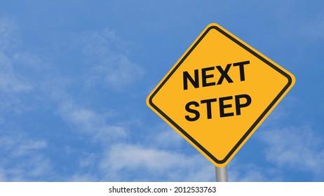 Next Step Road Sign On Clear Blue Sky With Rapid Moving Clouds For Text Placement