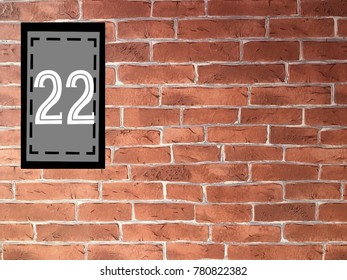 Number 22 on gray rectangle place on old brick wall with copy space for your text design, vintage style. Concept be used for calendar,page,date,age,card,birthday and background for presentation. - Powered by Shutterstock