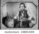 Occupational portrait of a blacksmith, working on a horseshoe at an anvil, other tools to his side. quarter plate daguerreotype, 1840-1860