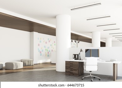 Office interior with a computer standing on a desk, dark wooden floor, round columns and a white wall with sticky notes. 3d rendering, mock up