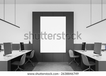 Office interior with large vertical blank poster mockup on dark wall panel, minimalist workspace with computers and chairs, 3D Rendering