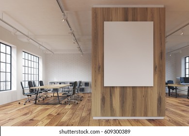 Office With A Poster Hanging On A Wooden Wall, Rows Of Tables With Computers And Wooden Floor. 3d Rendering. Mock Up