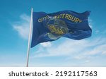 official flag of Waterbury, Connecticut untied states of America at cloudy sky background on sunset, panoramic view. USA travel and patriot concept. copy space for wide banner. 3d illustration