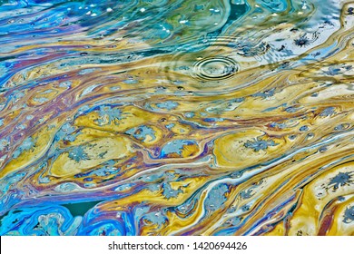 Oil Spill On A Waterway In Houston, Texas With Rainbow Colors, Signs Of Oil Pollution From Factory Runoffs, And A Danger To The Natural Environment.