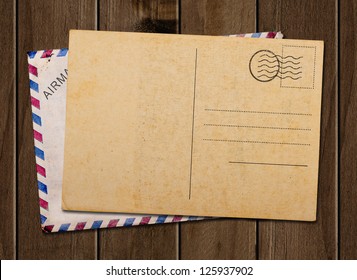 Old Blank Post Card And Envelope, On Wooden Table.