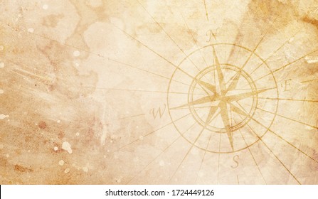 Old compass on the vintage paper background