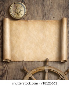 Old Map Scroll With Compass And Steering Wheel On Wood Table. Adventure And Travel Concept. 3d Illustration.