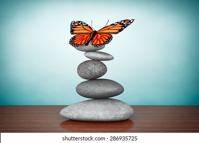 Old Style Photo. Balanced stones with butterfly on the table