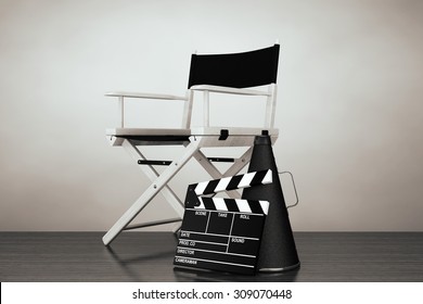 Old Style Photo. Director Chair, Movie Clapper And Megaphone On The Floor