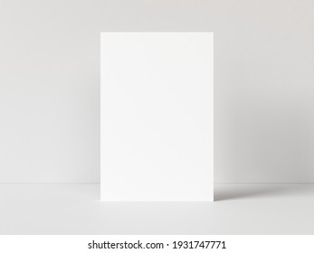 One blank vertical rectangle poster template standing on white table with white background. 3D illustration - Powered by Shutterstock