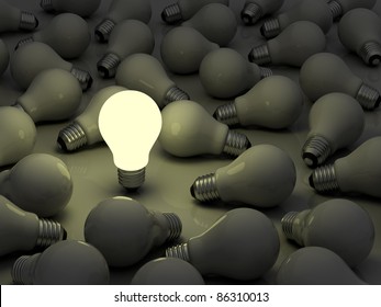 One glowing light bulb standing out from the unlit incandescent bulbs