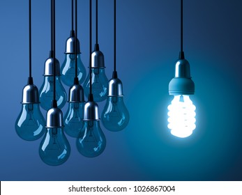 One Hanging Eco Energy Saving Light Bulb Glowing And Standing Out From Unlit Incandescent Bulbs On Dark Blue Background , Leadership And Different Creative Idea Concept. 3D Rendering.