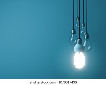 One Hanging Eco Energy Saving Light Bulb Glowing And Standing Out From Unlit Incandescent Bulbs On Dark Green Pastel Color Background , Leadership And Different Creative Idea Concept. 3D Rendering.