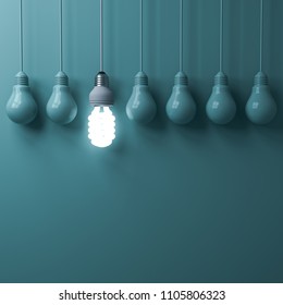 One Hanging Eco Energy Saving Light Bulb Glowing And Standing Out From Unlit Incandescent Bulbs On Green Pastel Color Wall Background , Leadership And Different Creative Idea Concepts . 3D Rendering.