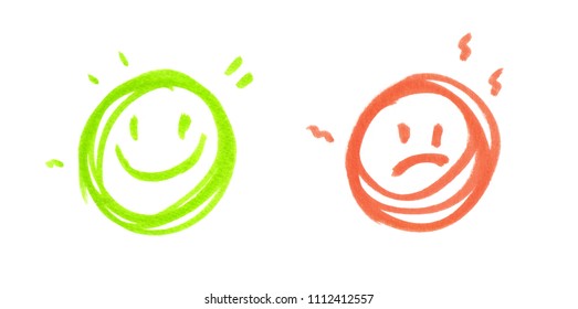 One round green happy face   one round red sad face painted in highlighter felt tip pen clean white background