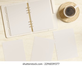 Open ring bound A5 leather planner mockup on desk and blank planner inserts. Coffee cup to customise. Top view flatlay as a realistic 3d rendering.