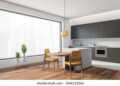 Open Space Home Interior With Grey Wall And Black Kitchen Set, Panoramic Window, Side View. Dining Table With Yellow Chairs, City View On Skyscrapers, 3D Rendering No People