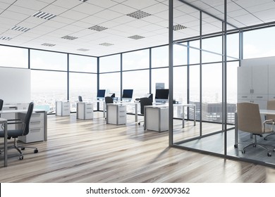 Open space office environment with rows of computer desks and loft windows. Aquarium like meeting room. 3d rendering mock up