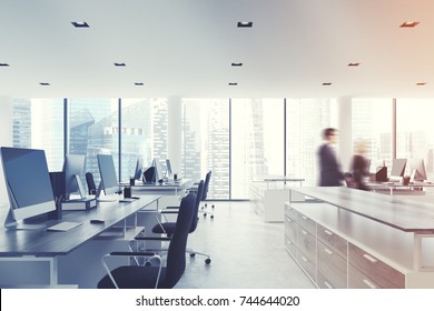 Open Space Office Interior With White Walls And Ceiling, A Concrete Floor And Panoramic Windows. A Row Of Computer Desks And Bookshelves. Side View, People. 3d Rendering Mock Up Toned Image