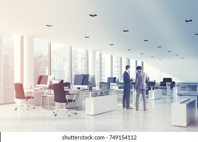 Open Space Office Interior With White Walls And Ceiling, A Concrete Floor And Panoramic Windows. A Row Of Computer Desks With Blank Screens. Side View, People. 3d Rendering Mock Up Toned Image