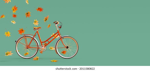 Orange bicycle arriving with falling dry leaves on green background. Autumn is coming concept image 3D Rendering, 3D Illustration