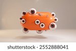 Orange oblong capsule covered with eyeballs with red veins floating slightly above a white surface, creating a surreal and unsettling scene