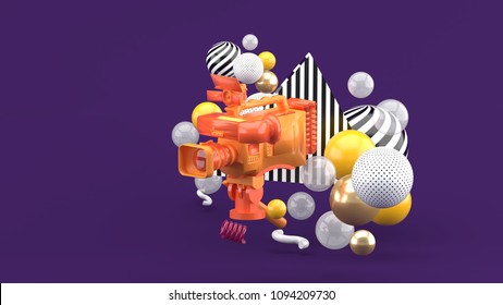 An Orange Video Camera Surrounded By Colorful Balls On A Purple Background.-3d Render.