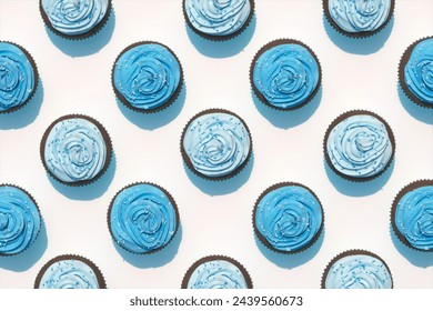 Overhead view captures enticing array of chocolate cupcakes adorned with striking blue frosting and colorful sprinkles, neatly aligned on a delicate pastel surface.