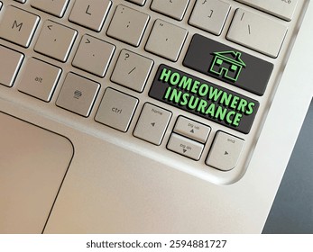 Overhead view of computer keys with the words Homeowners Insurance and a home for home Insurance concept emphasizing the importance of it to protect homes and belongings.  