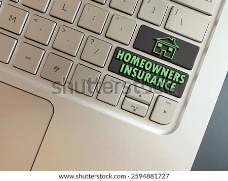 Overhead view of computer keys with the words Homeowners Insurance and a home for home Insurance concept emphasizing the importance of it to protect homes and belongings.  