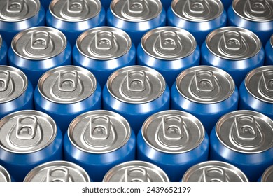 Overhead view showcasing a dense, uniform pattern formed by sealed blue aluminum beverage cans, emphasizing their sleek, reflective surfaces.