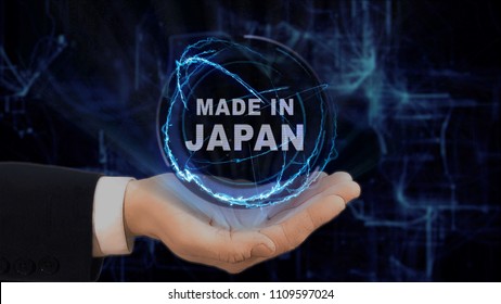 Painted Hand Shows Concept Hologram Made In Japan On His Hand. Drawn Man In Business Suit With Future Technology Screen And Modern Cosmic Background