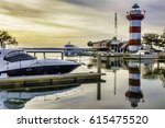 Painterly waterscape of marina and lighthouse near sunset on Hilton Head Island, South Carolina, USA, with digital painting effect, for coastal, marine and travel themes