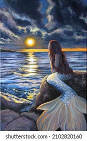 The painting depicts a beautiful long-haired mermaid who came out of the sea and sat on the stones on the shore to look at the horizon and enjoy the sunset over the sea. What is she thinking about?