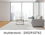 Panoramic living room. Side view with the grey sofa and carpet. Wooden flooring and top of the coffee table. White light interior with the glass wall on the right. 3d rendering