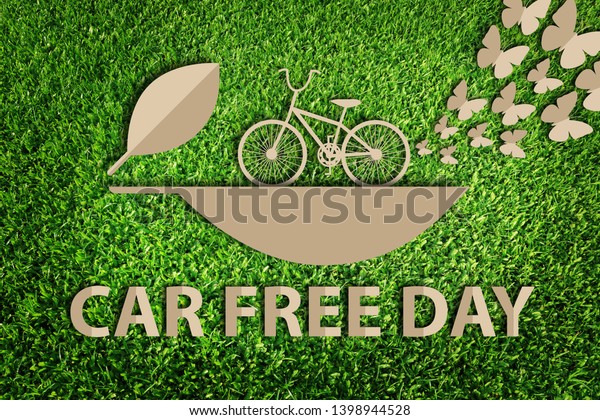 Paper art\
style of eco concept on green grass background. Eco bicycle. Go\
green concept. Car free day. Save the\
earth.