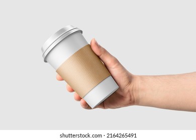 Paper coffee cup with sleeve in a hand mockup template, isolated on light grey background. High  resolution 3D illustration.