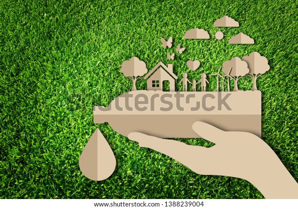 Paper cut of eco concept on green grass background. Save water concept. Save the earth.